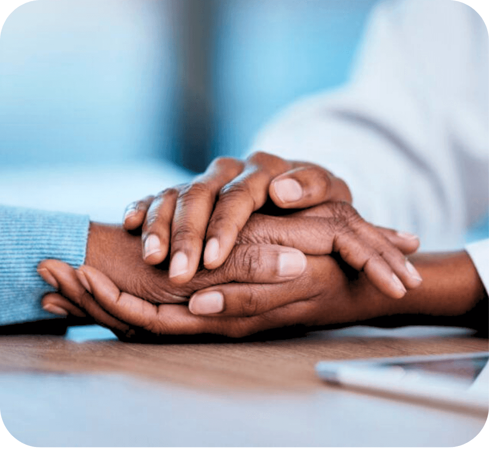 A caregiver holding a patient's hands