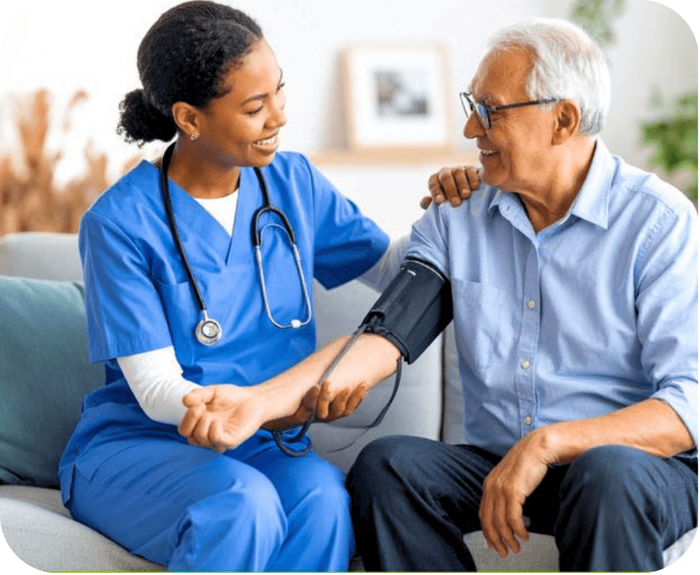 A nurse checking an elderly man's blood pressure at home